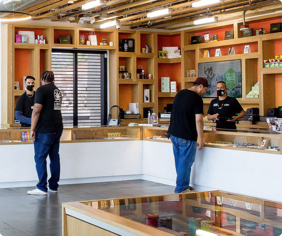 Seed to Sale Image | Two individals at a counter browsing Cannabis Selection